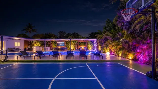 Lit pickleball court beside the villa at night