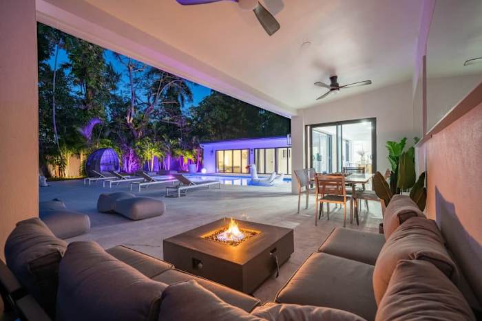 Fenced backyard of Villa Azure with the heated saltwater pool, loungers and a large daybed