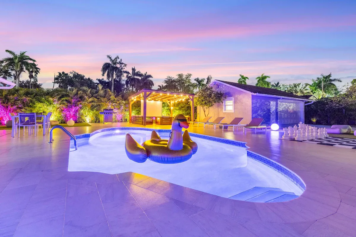 Fenced private backyard of Villa Serena with the heated pool, loungers and a large cooler